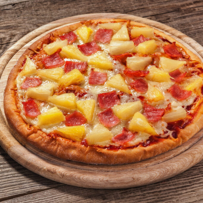 Hawaiian pizza on the old board.